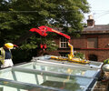 The P11104 lifter installing glass on a rooftop